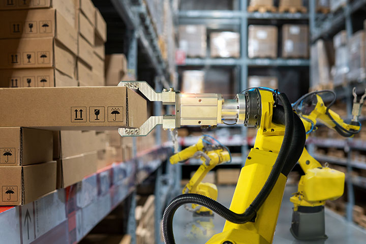 Image: Robotic arms pulling packages from shelves in warehouse.