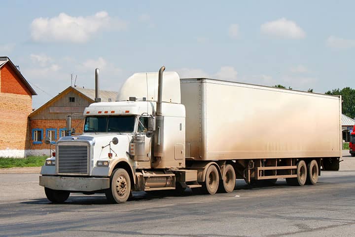 Image: Logistics graphic with blurred warehouse in the background.