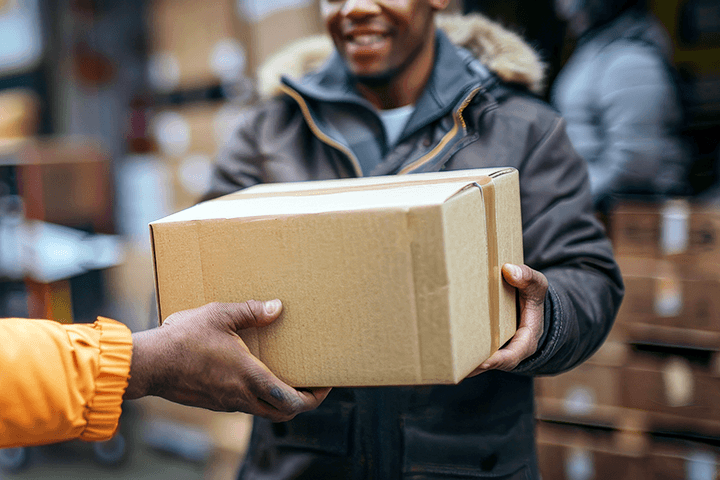 Image: Courier handing a package to a satisfied recipient.