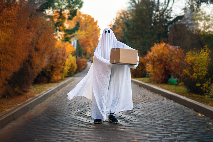 Image: A ghost in the street holding a shipping package for delivery.