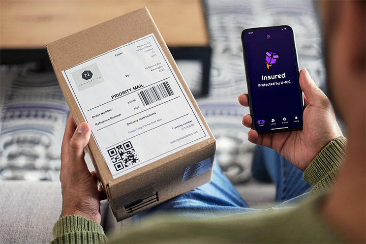 Image: Insured package with U-PIC Shipping Insurance confirmation on phone.