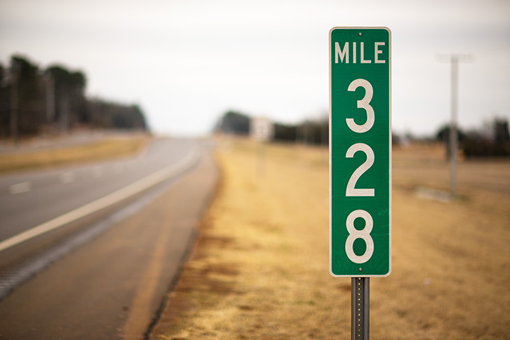 Image: Mile marker along highway that reads 'Mile 328'.