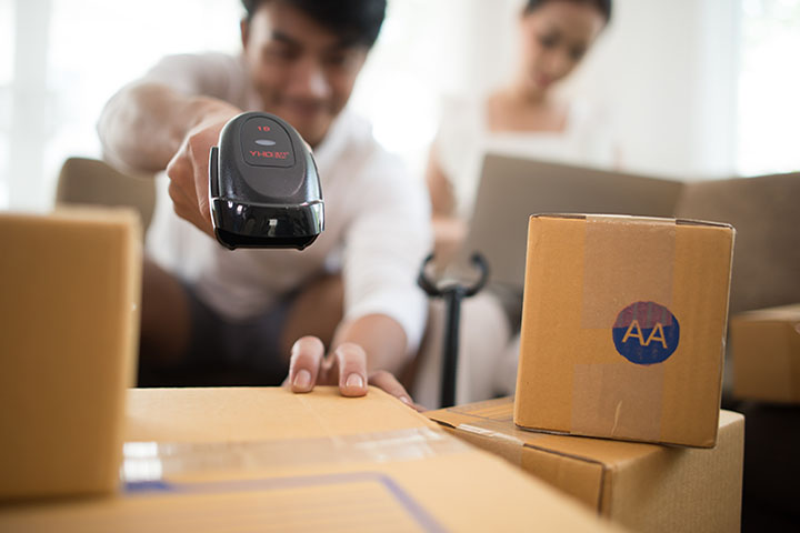 Couple preparing packages for shipping