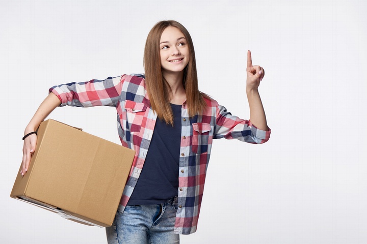 Girl Holding One Finger Up With Box