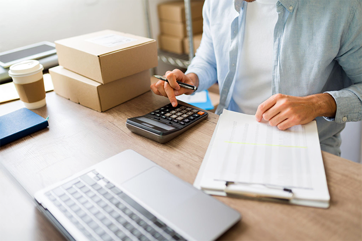 Image: An ecommerce seller calculating shipping rates.