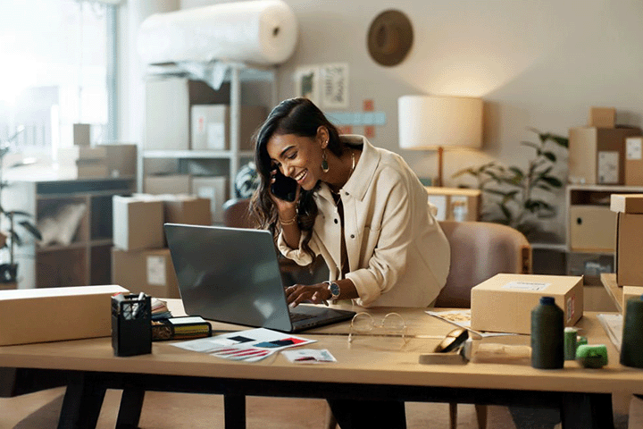 Image: Happy ecommerce seller handling an order for her small business.