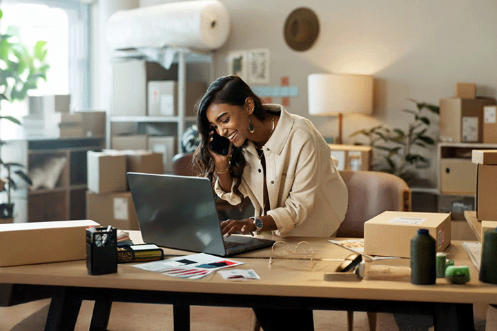 Image: Happy ecommerce seller handling an order for her small business.