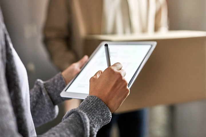 Image: Person signing an electronic document on a tablet, representing the process of completing an affidavit.”