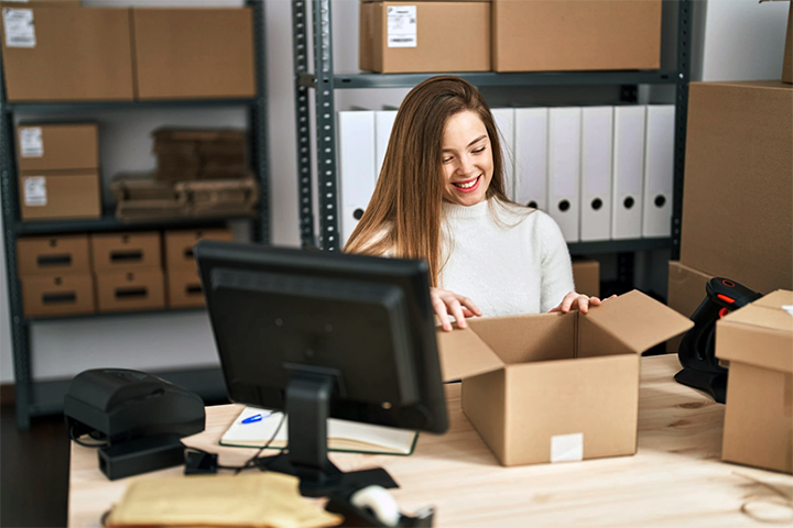 Image: Peaceful eCommerce seller packing a shipment.