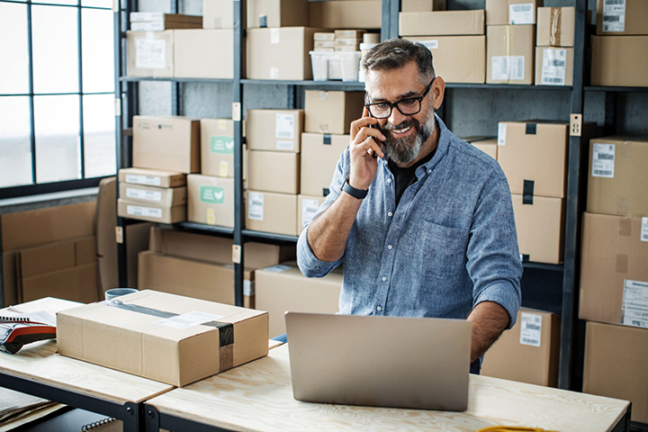 Image: Ecommerce seller looking over the U-PIC Shipping Insurance guidebook.
