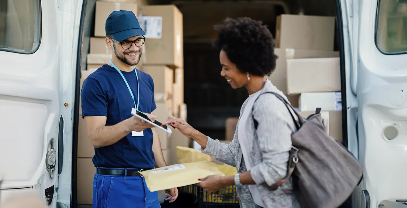 Image: A delivery driver delivering a package on behalf of a shipping carrier.