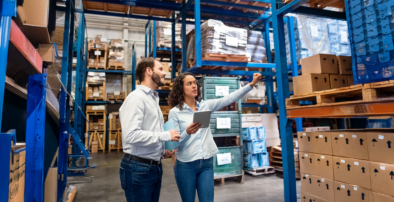 Image: Workers using enterprise resource planning software in a modern warehouse.
