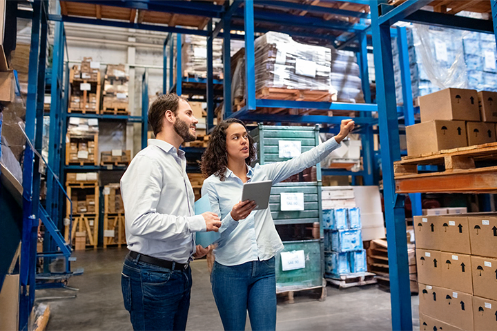 Image: Workers using enterprise resource planning software in a modern warehouse.