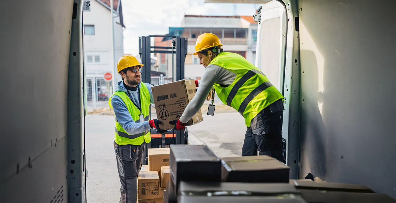 Image: Freight forwarders loading a truck with packages.