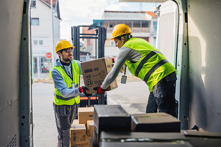 Image: Freight forwarders loading a truck with packages.