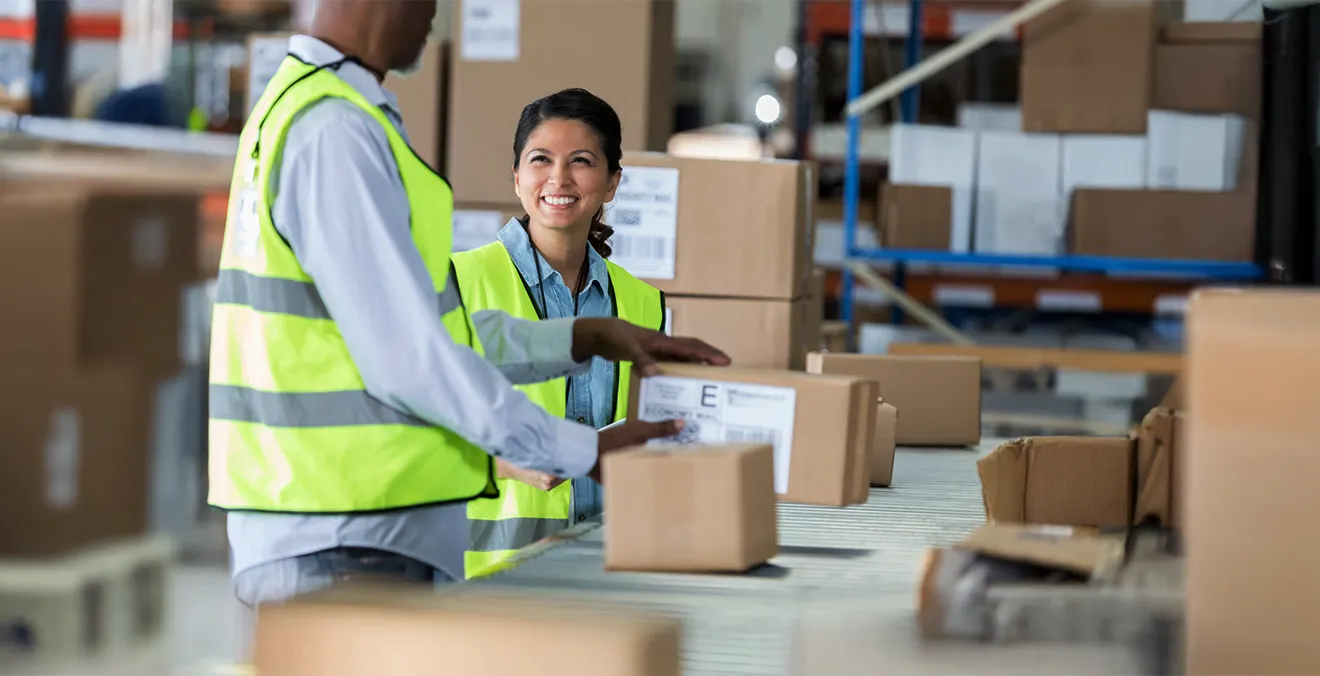 Image: Two workers fulfilling orders in a warehouse setting.