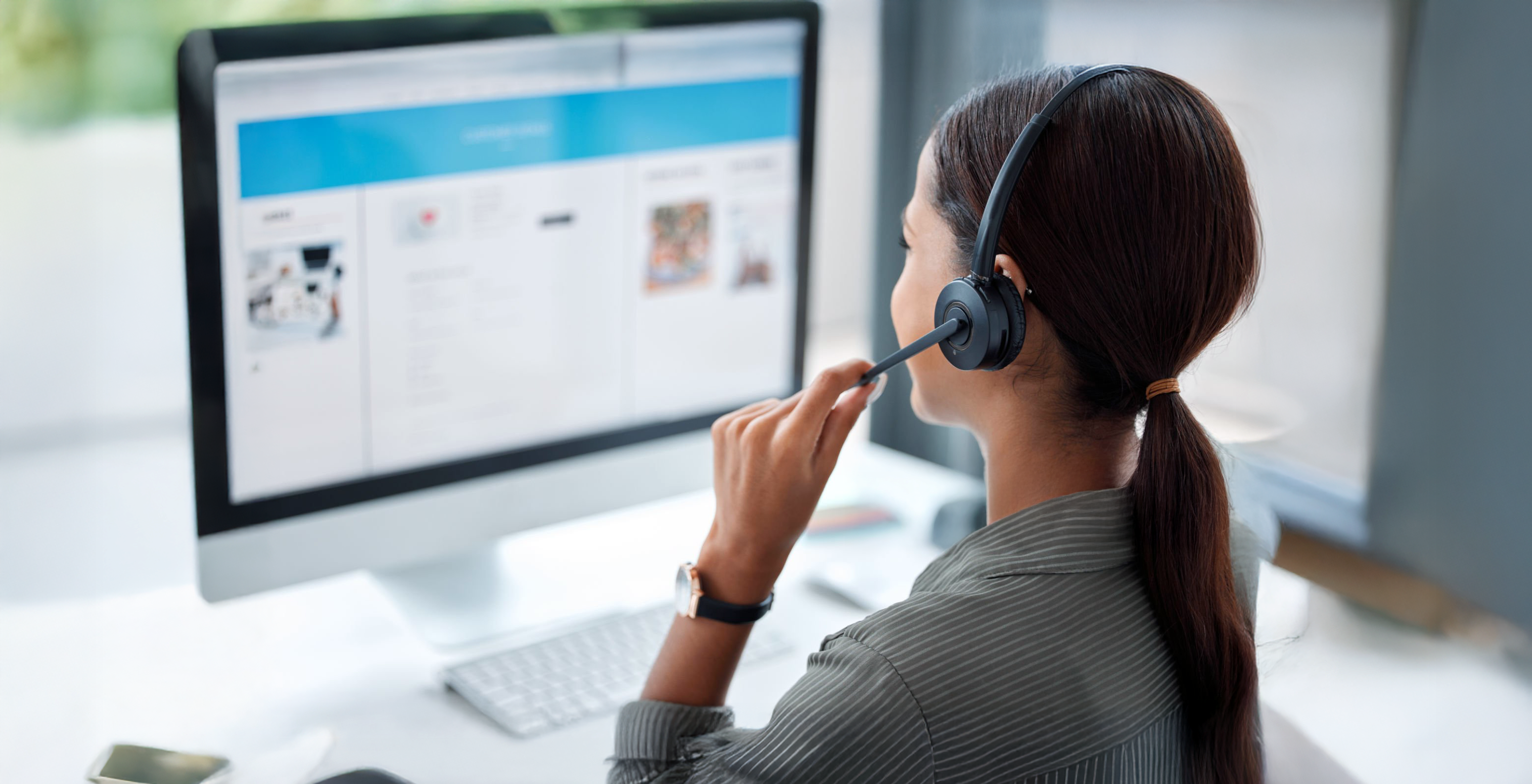Image: A worker managing orders at a desk.