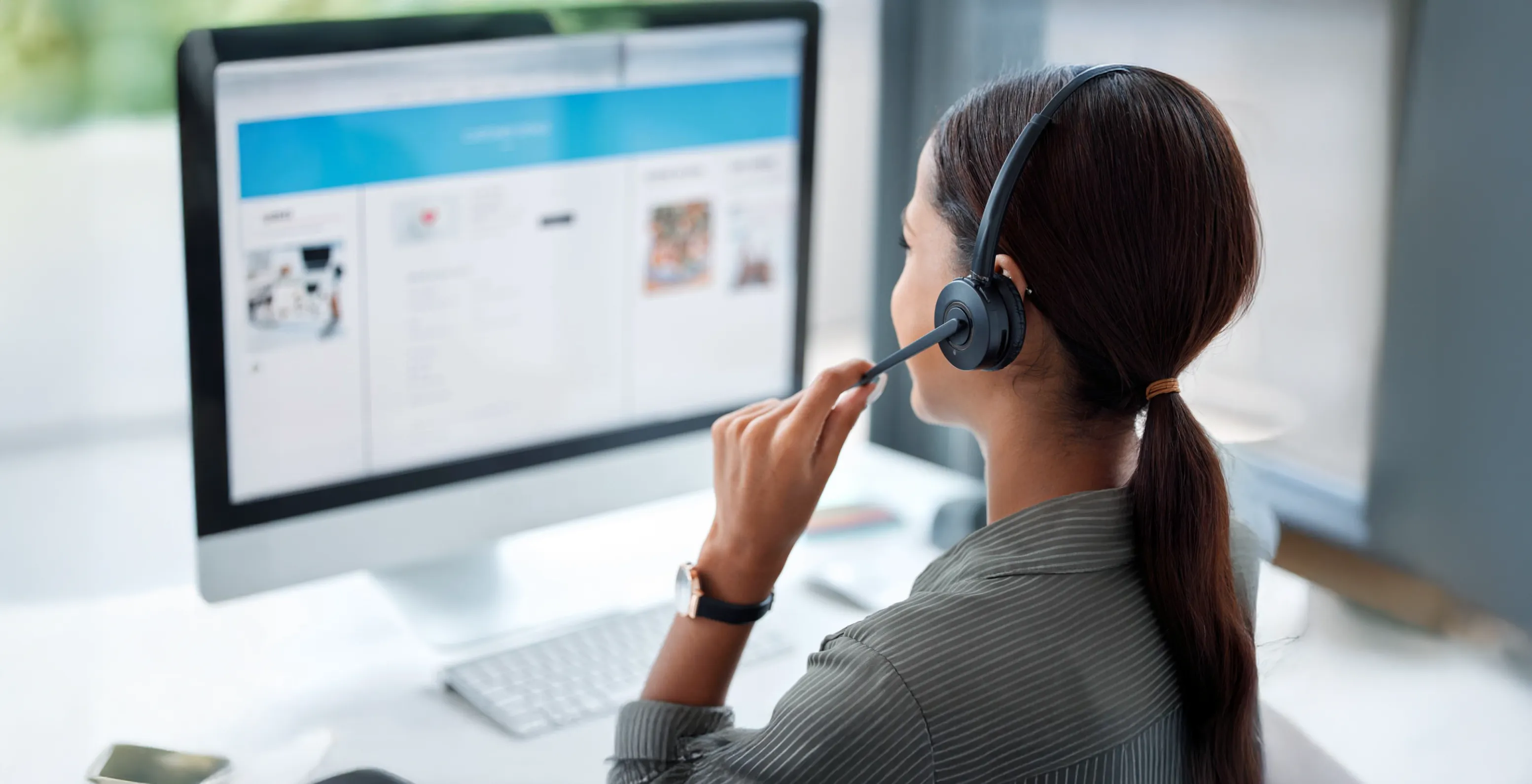 Image: A worker managing orders at a desk.