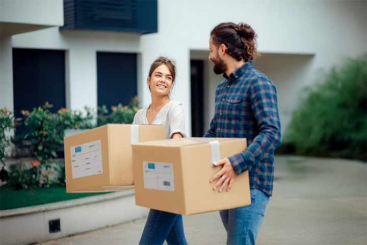 Image: Ecommerce sellers walking outdoors while carrying cardboard shipping boxes, representing the 'Walk' phase of U-PIC’s integration process.