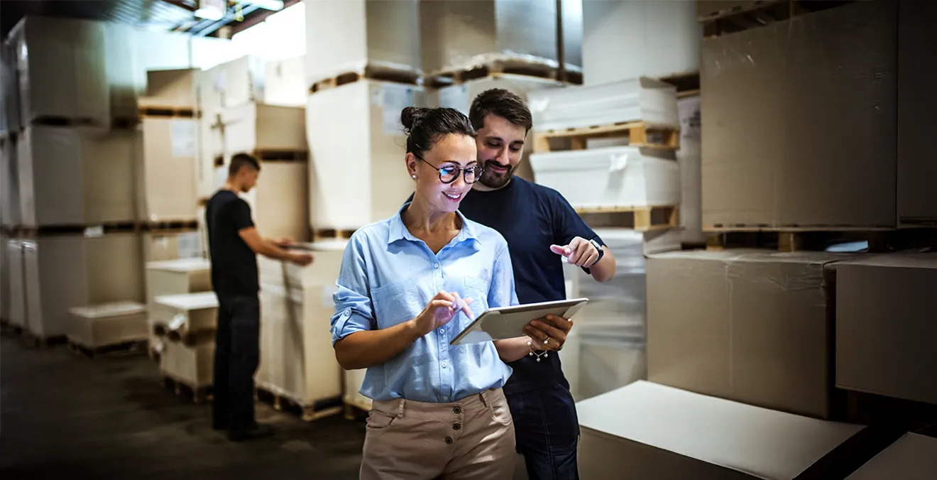 Image: Workers using a warehouse management system.