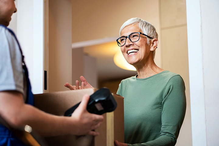 Image: A happy customer receiving an insured shipment during delivery.